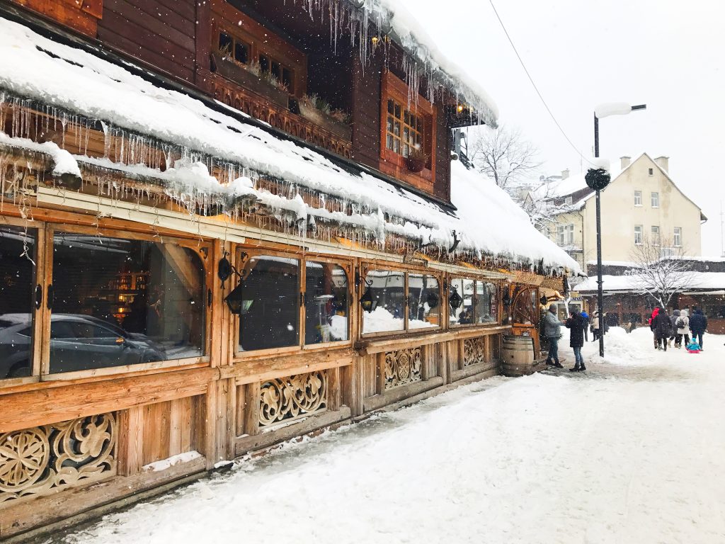 Highlander wooden restaurant in winter tourist town - Krupówki, Zakopane, Poland